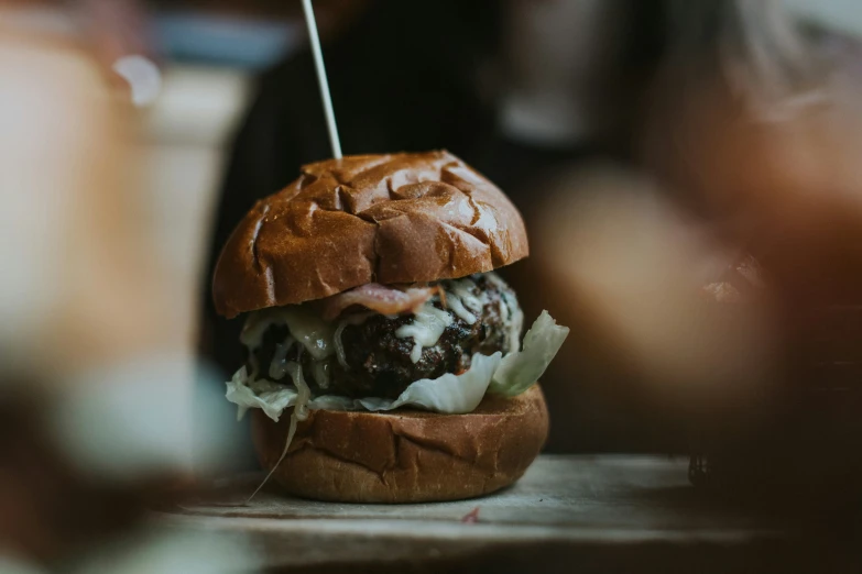 a close up of a burger sitting on a table