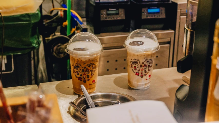 a group of two cups sit on a counter top