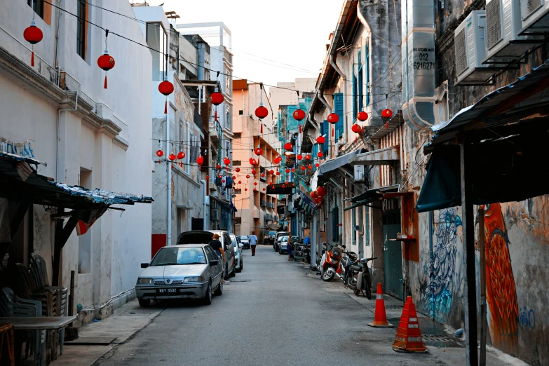 there are many red chinese lanterns hanging above the street