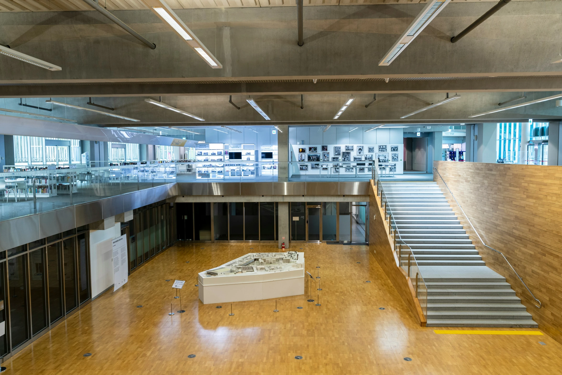 a large open building with wood floors and a white box sitting in the middle