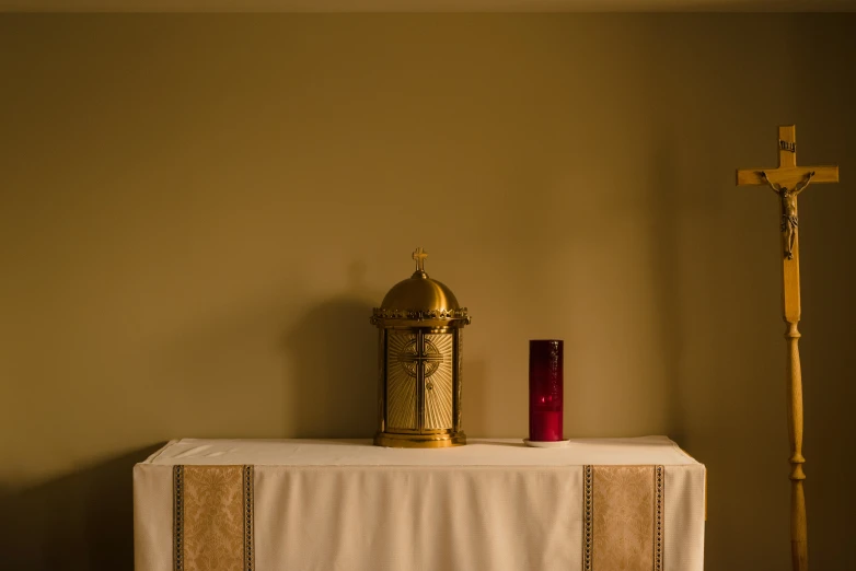 a church altar with a candle and cross on top