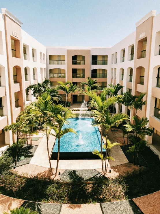 an aerial view of a pool surrounded by resort building