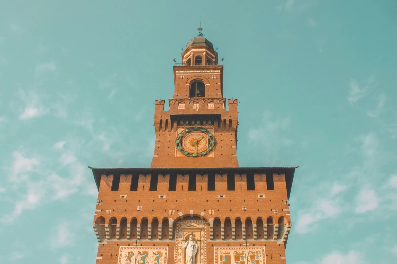 a large brick building with a tower clock