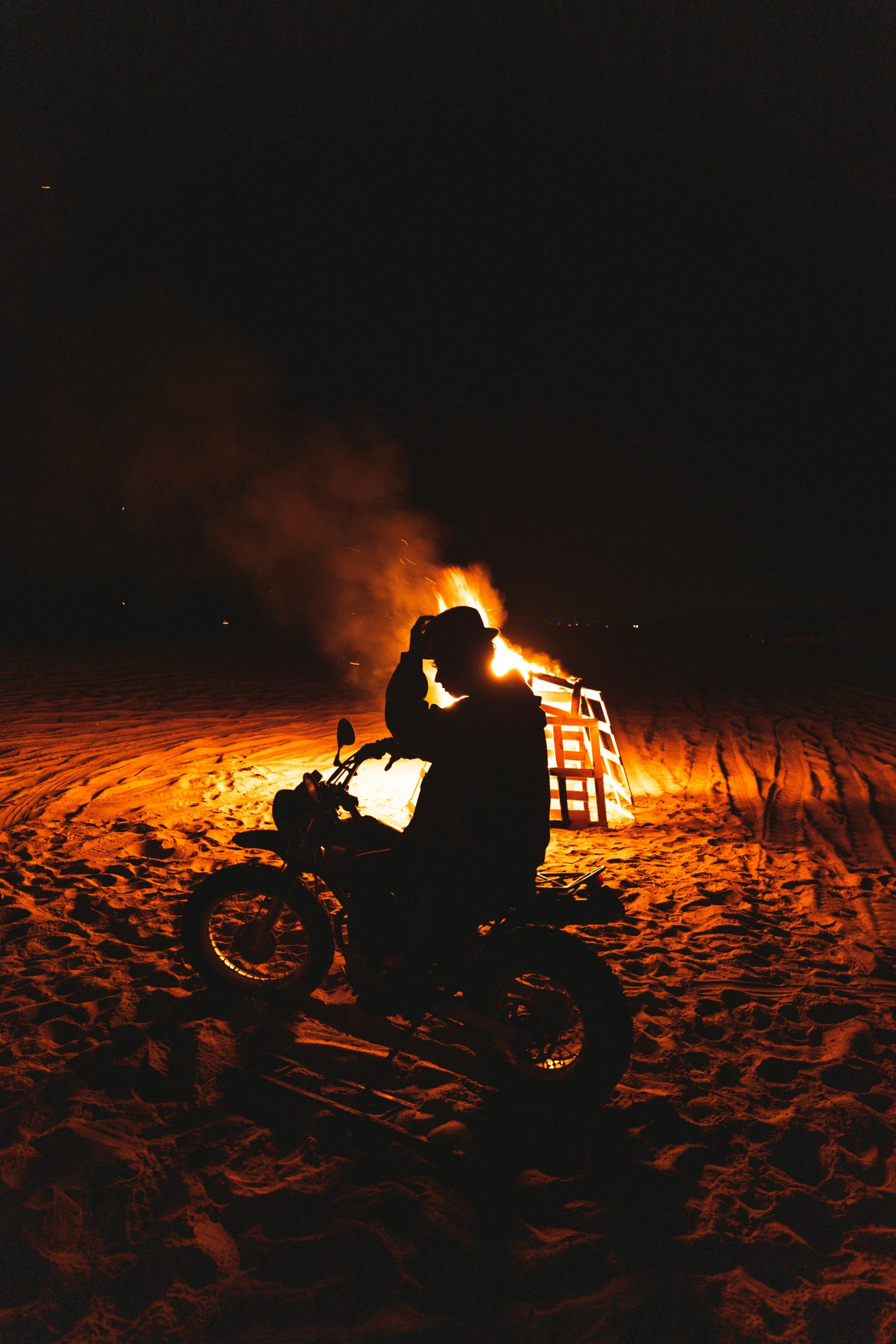 man riding motorcycle at night in desert area