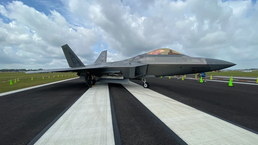 a jet plane sits parked on the runway