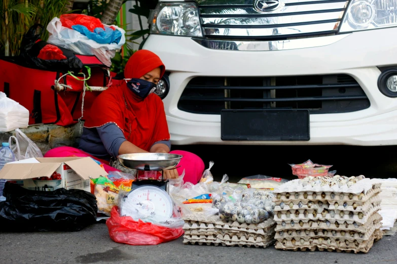 a person in red clothing sitting by some food