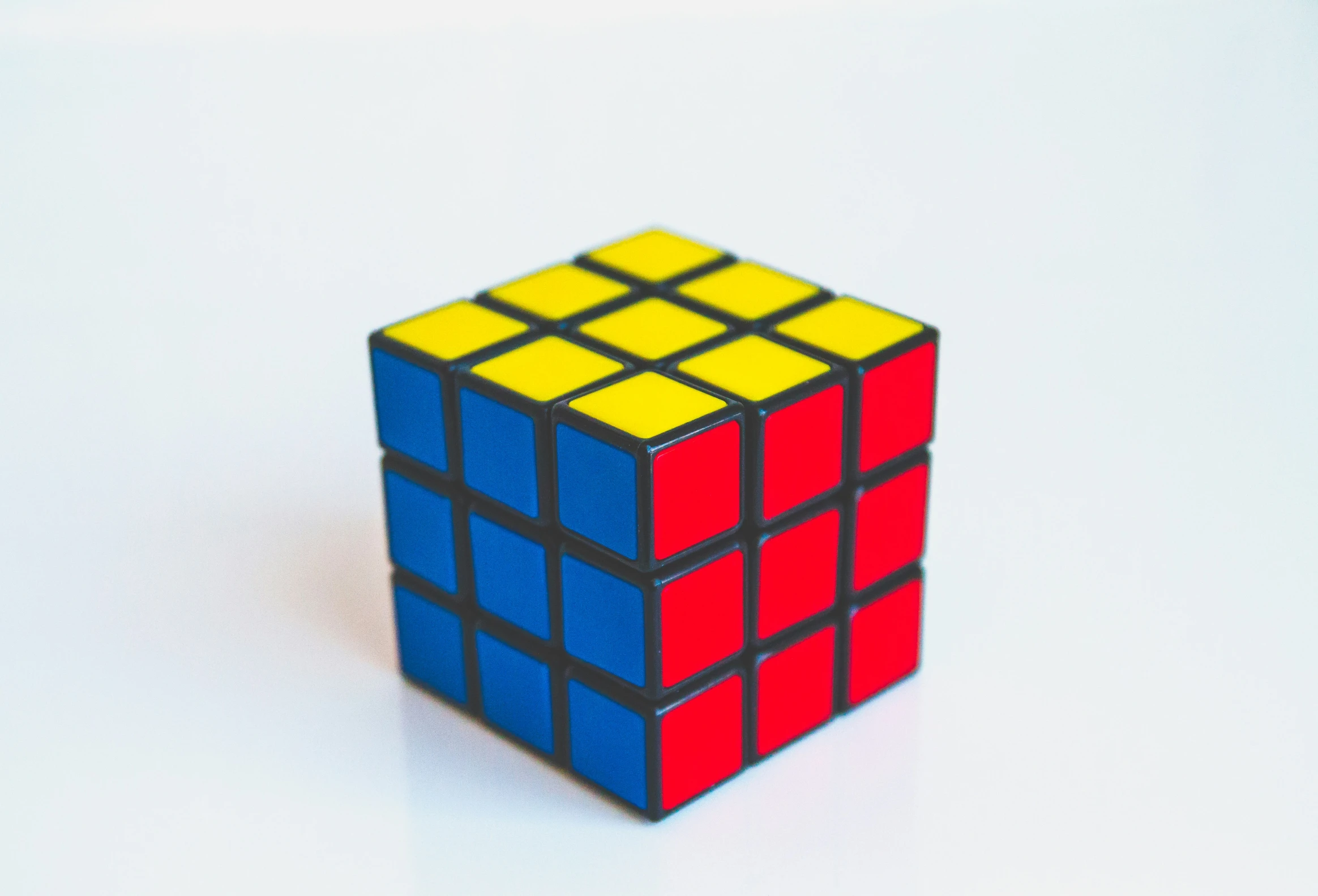 a rubik cube sitting on a white table