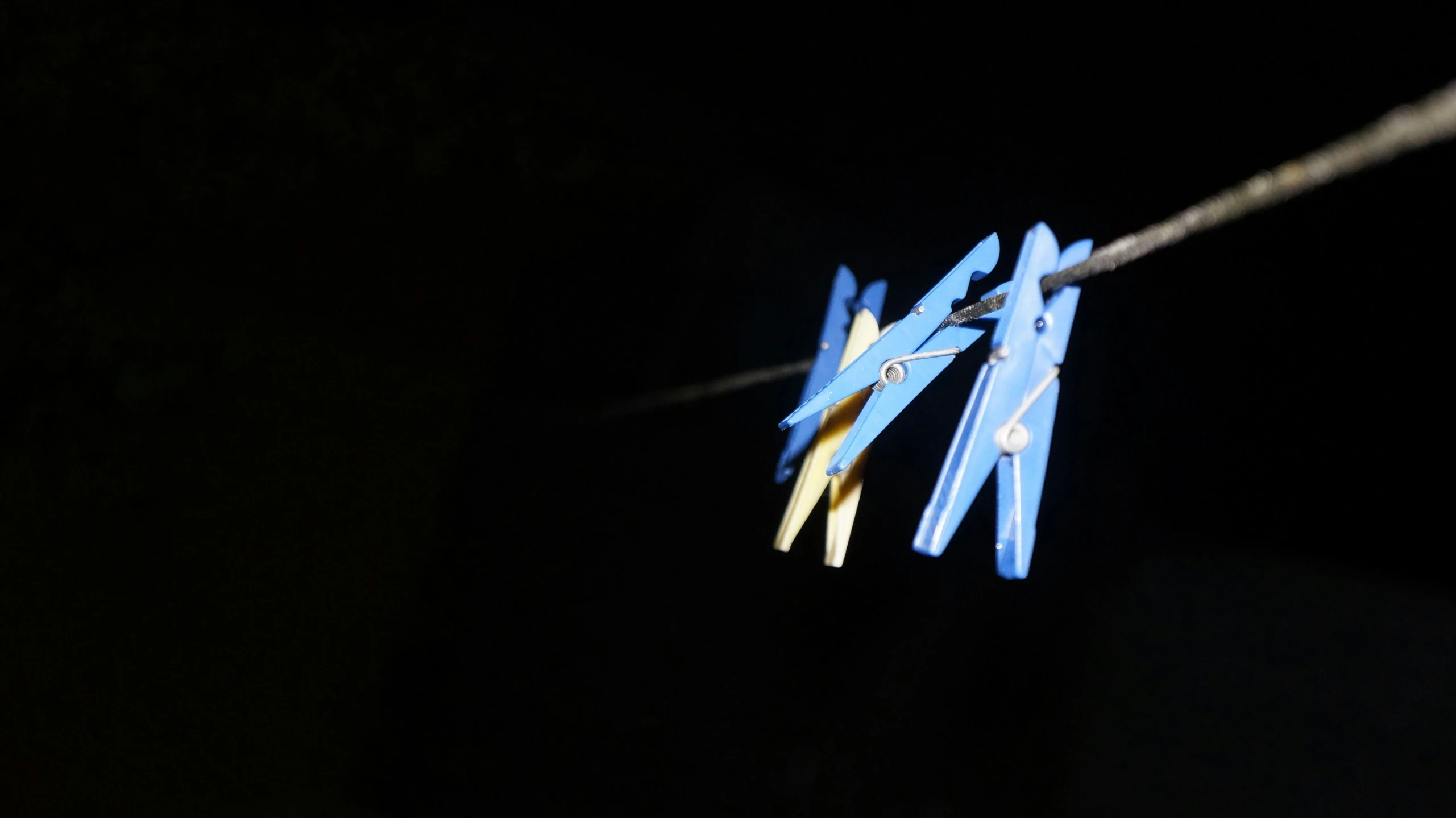 three blue planes are tied up on a string