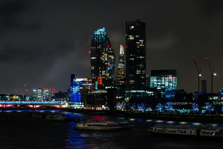 night s of two boats on the river in front of skyscrs