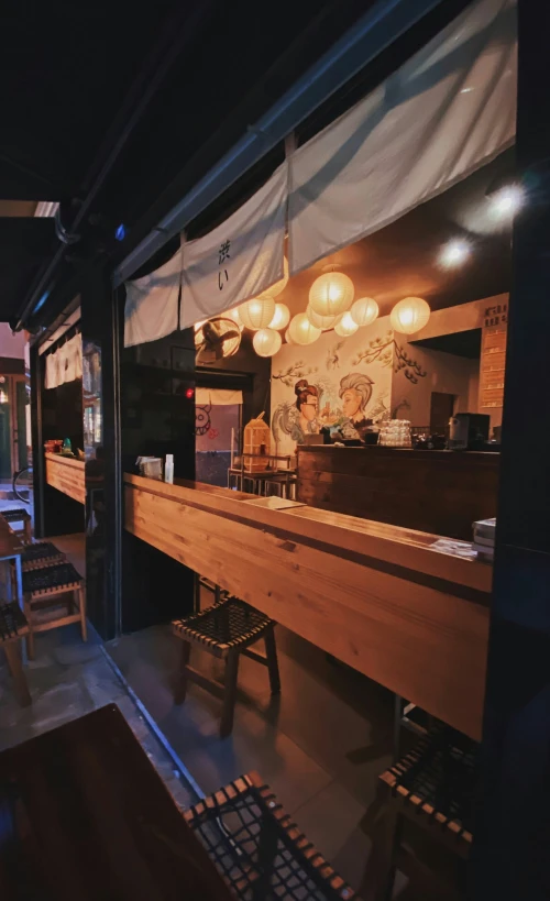 a restaurant with large wooden bar and tables