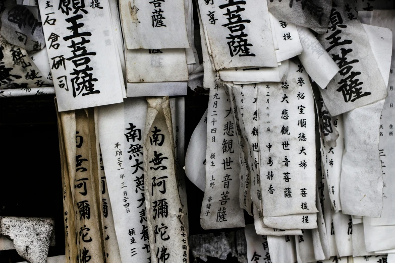 chinese characters are stacked on paper tags that says it is forbidden