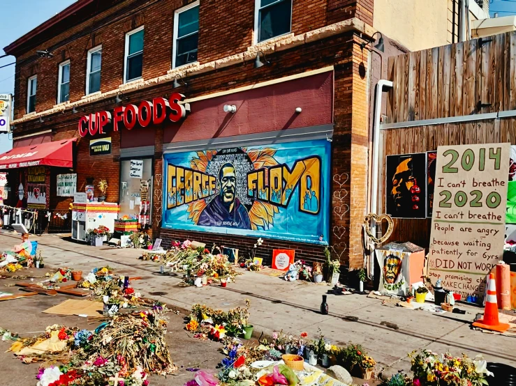 a bunch of fake flowers are in front of a store