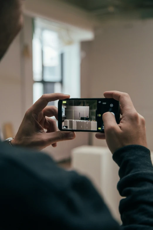 person holding up camera to take a picture of room