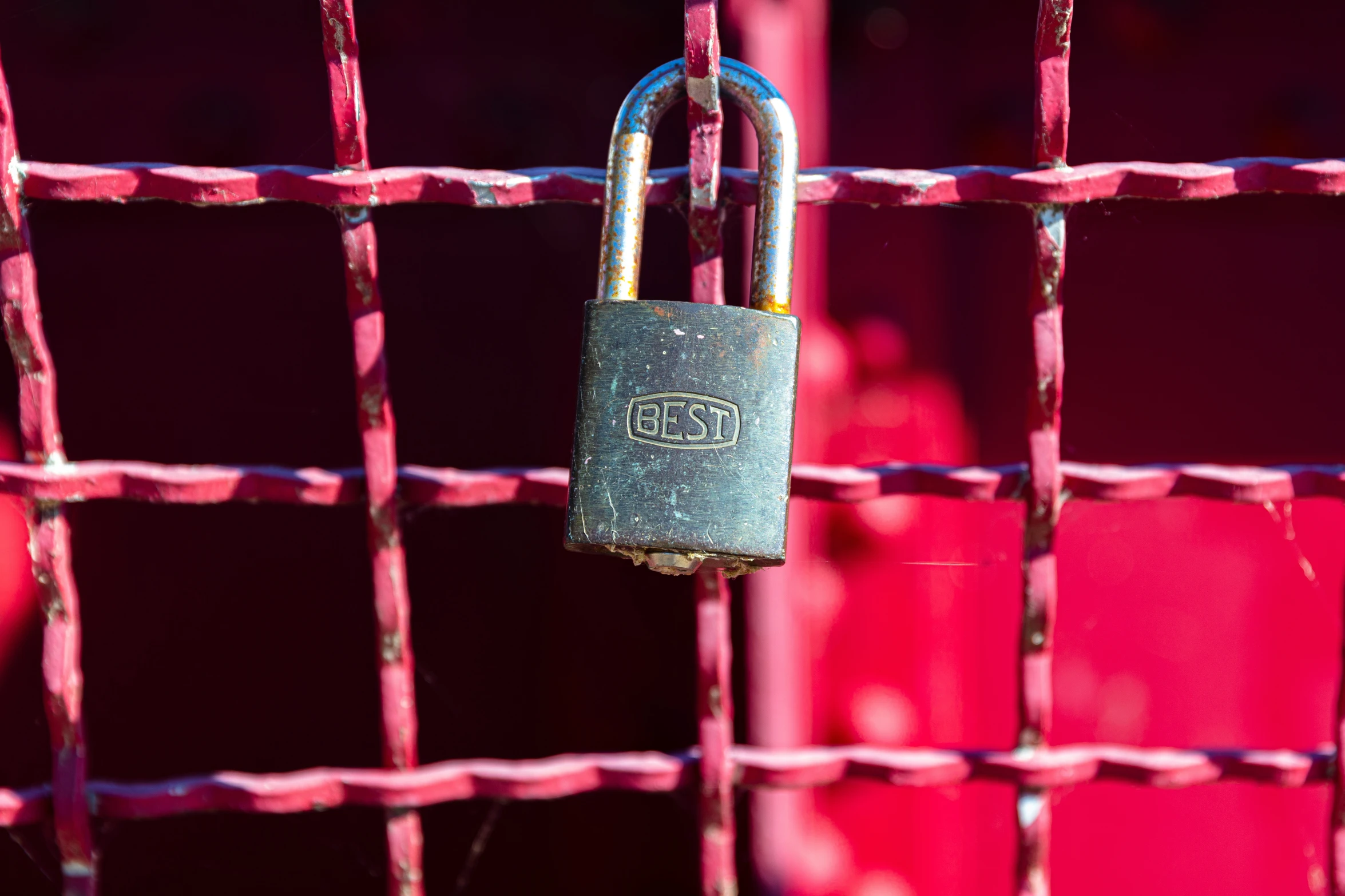 this is a padlock on a gate with red and purple background