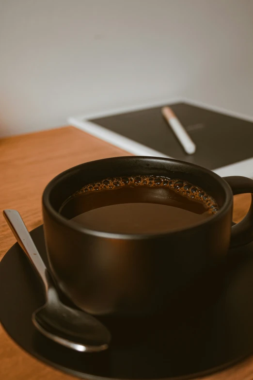 a cup of coffee sitting on top of a plate