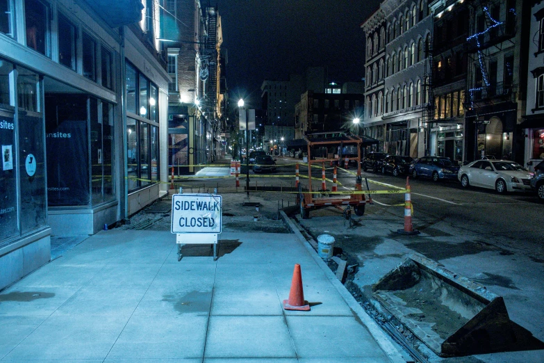 a sign that is in the middle of a sidewalk