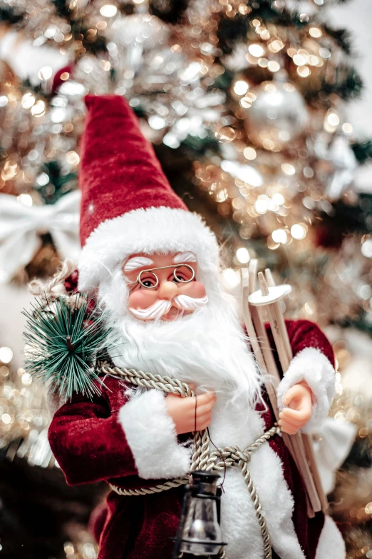 a close up of santa clause holding a bell