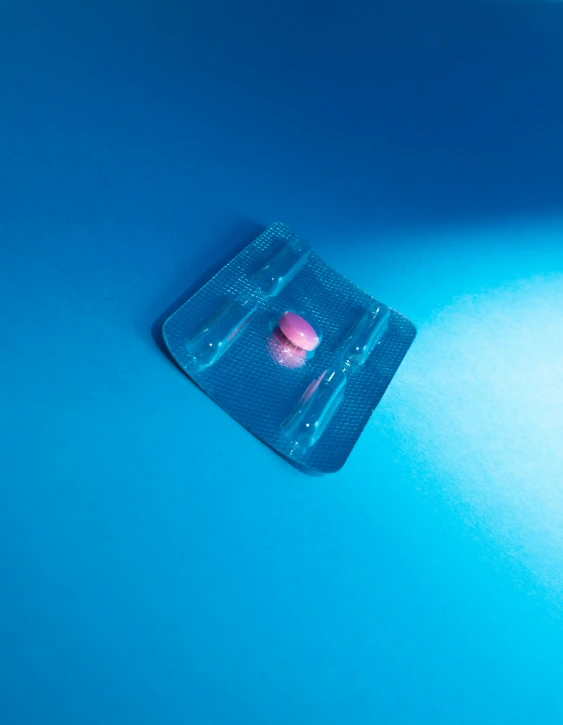 a single pill in a blue plastic package