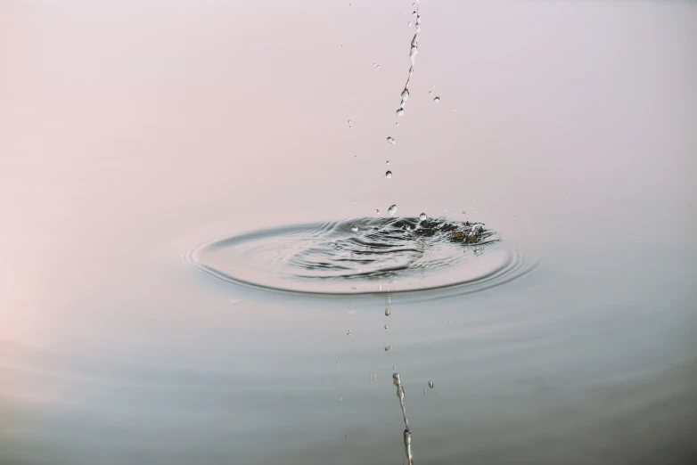 a rippler made of water on a gray lake