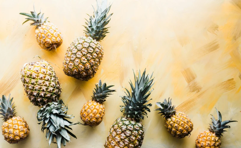 multiple pineapples lined up on top of each other