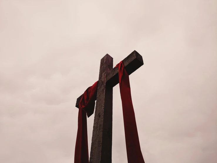 a cross with red tape wrapped around it
