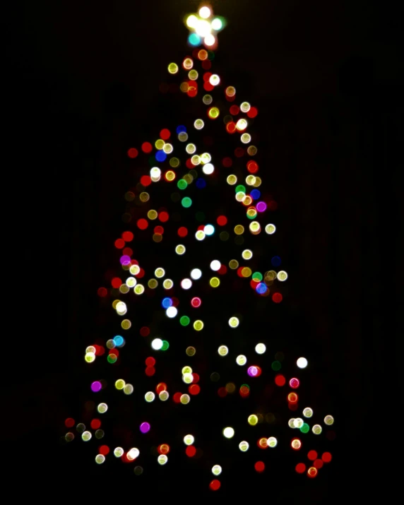 a bright colored lit christmas tree on display