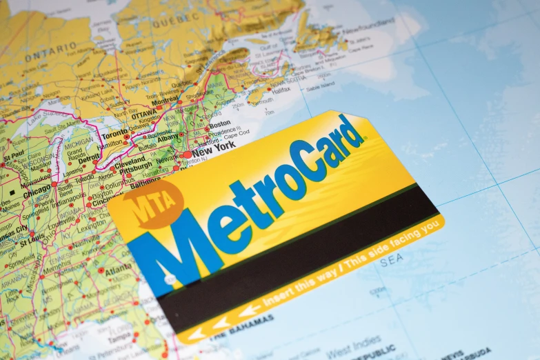 a metrocard resting on a map of the world