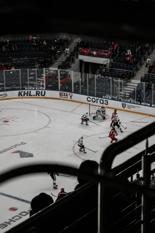 a hockey game is being played with empty stands