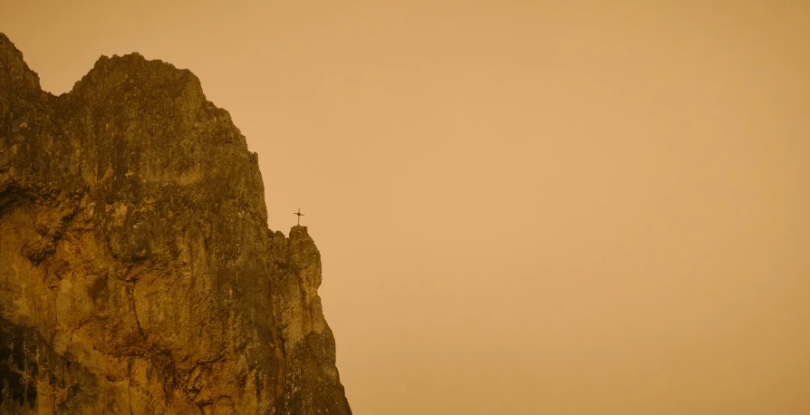 a rocky mountain and small group of people standing at the base