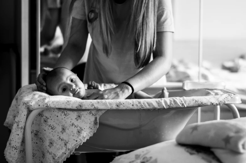 a young child in a crib is being held by its mother