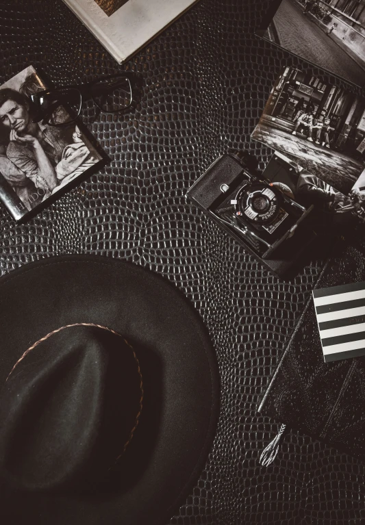 hats and other accessories are placed near a book on a table