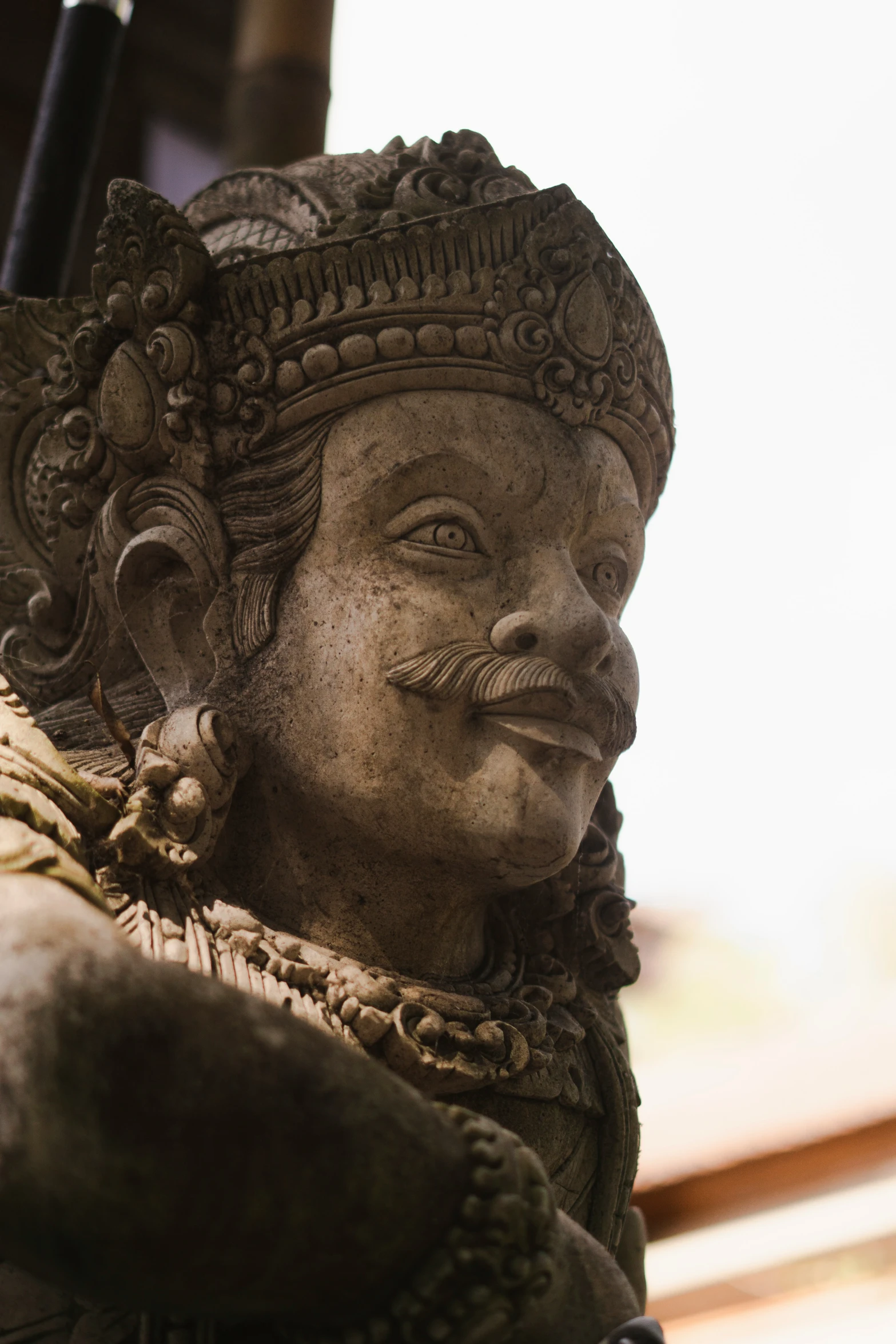 a statue is adorned with a large decorative hat