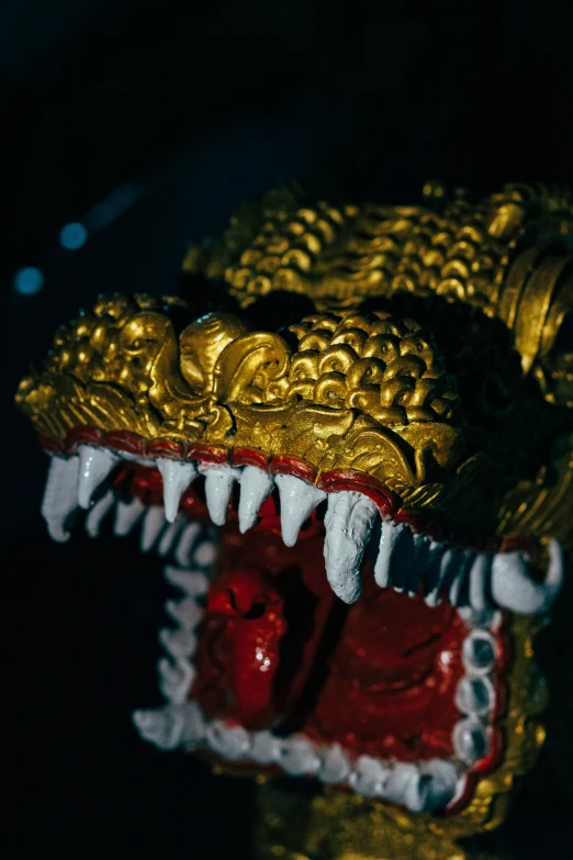 a large golden dragon statue with its mouth wide open