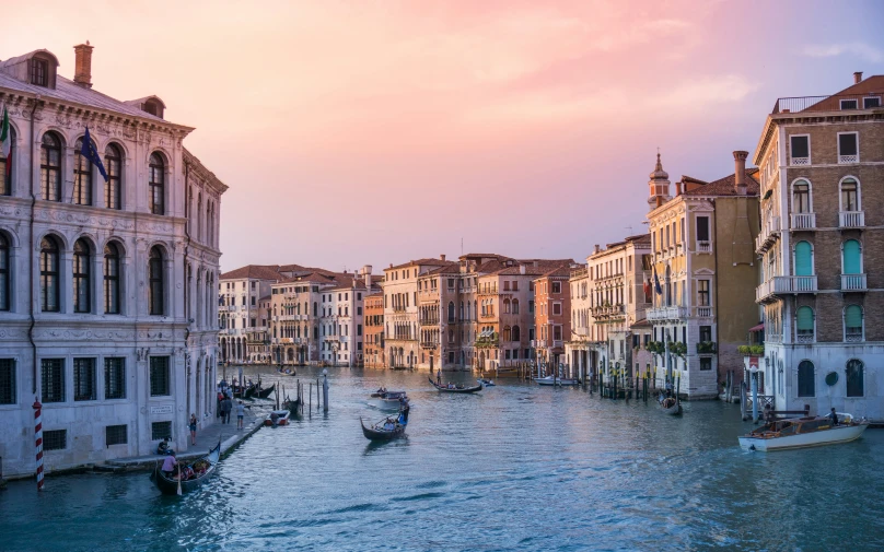 a view of a city that has several buildings and many boats in it