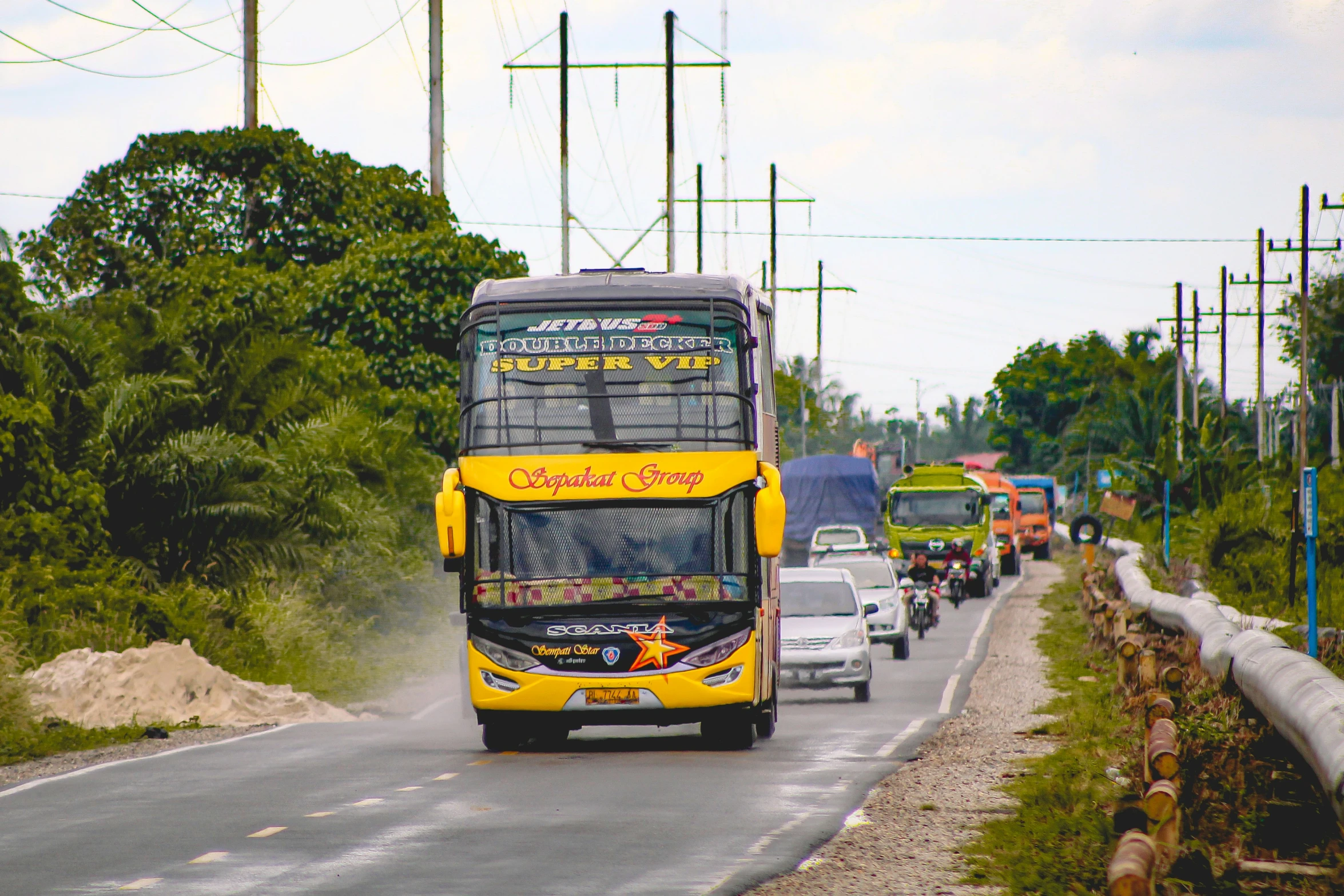 the yellow bus is travelling down the road