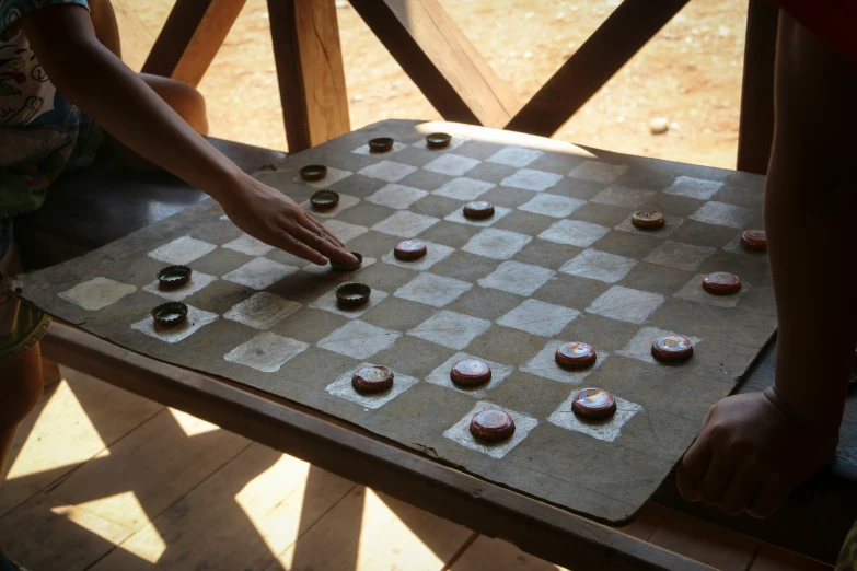 some people are playing a board game of checkers