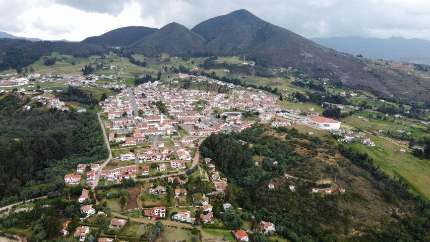 a scenic view of a town in the mountains