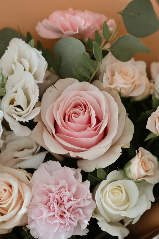 several pink and white flowers in a vase