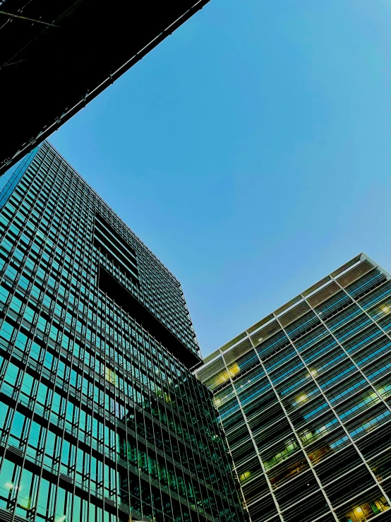 two buildings, one with glass windows and the other in perspective