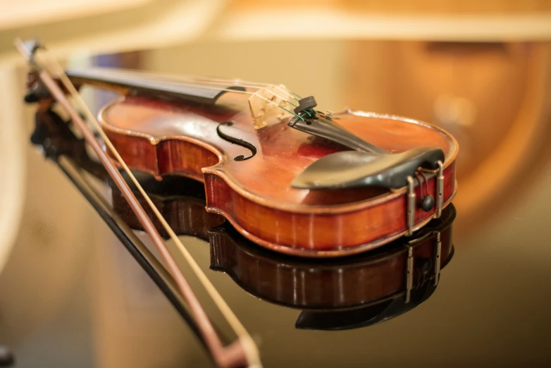 an old violin and bow that is on the counter