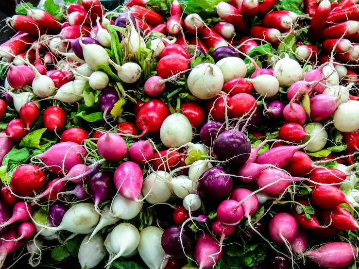 a bunch of radishes with leafy greens on top