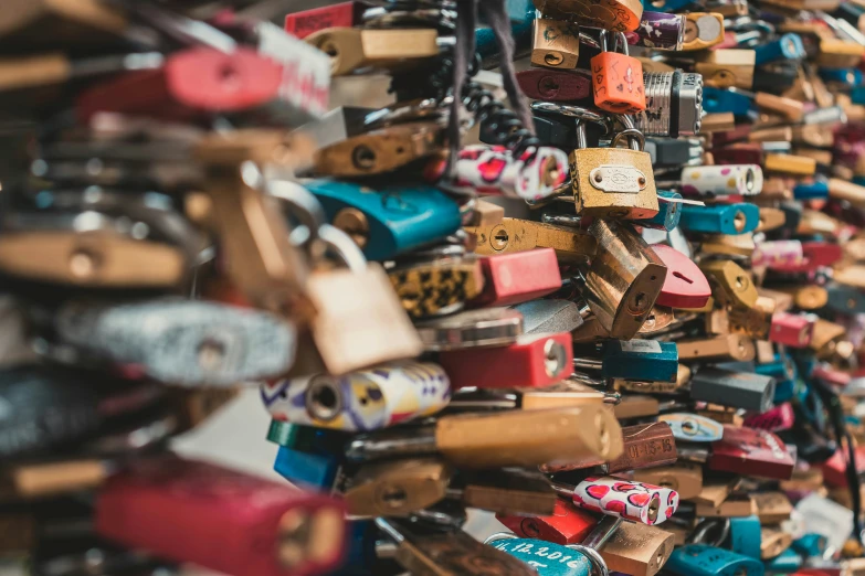 a wall covered with lots of different types and colors of locks