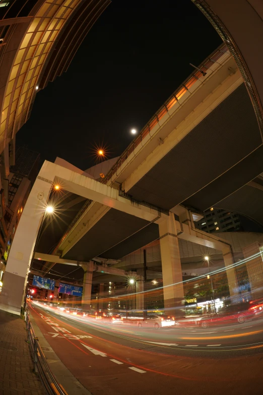 a busy city street at night filled with traffic