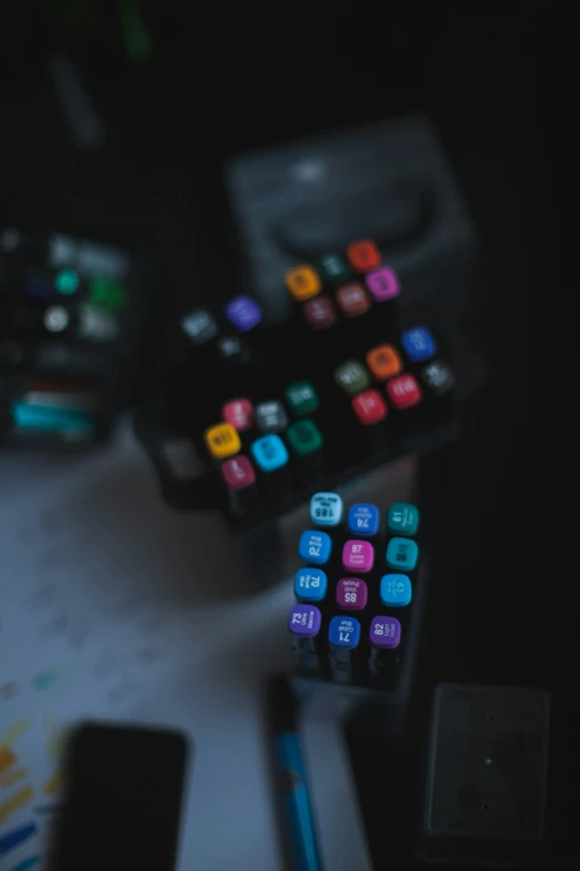 a computer keyboard and some colorful ons in the background