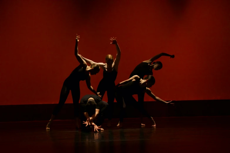 group of people on stage doing some stretching exercises