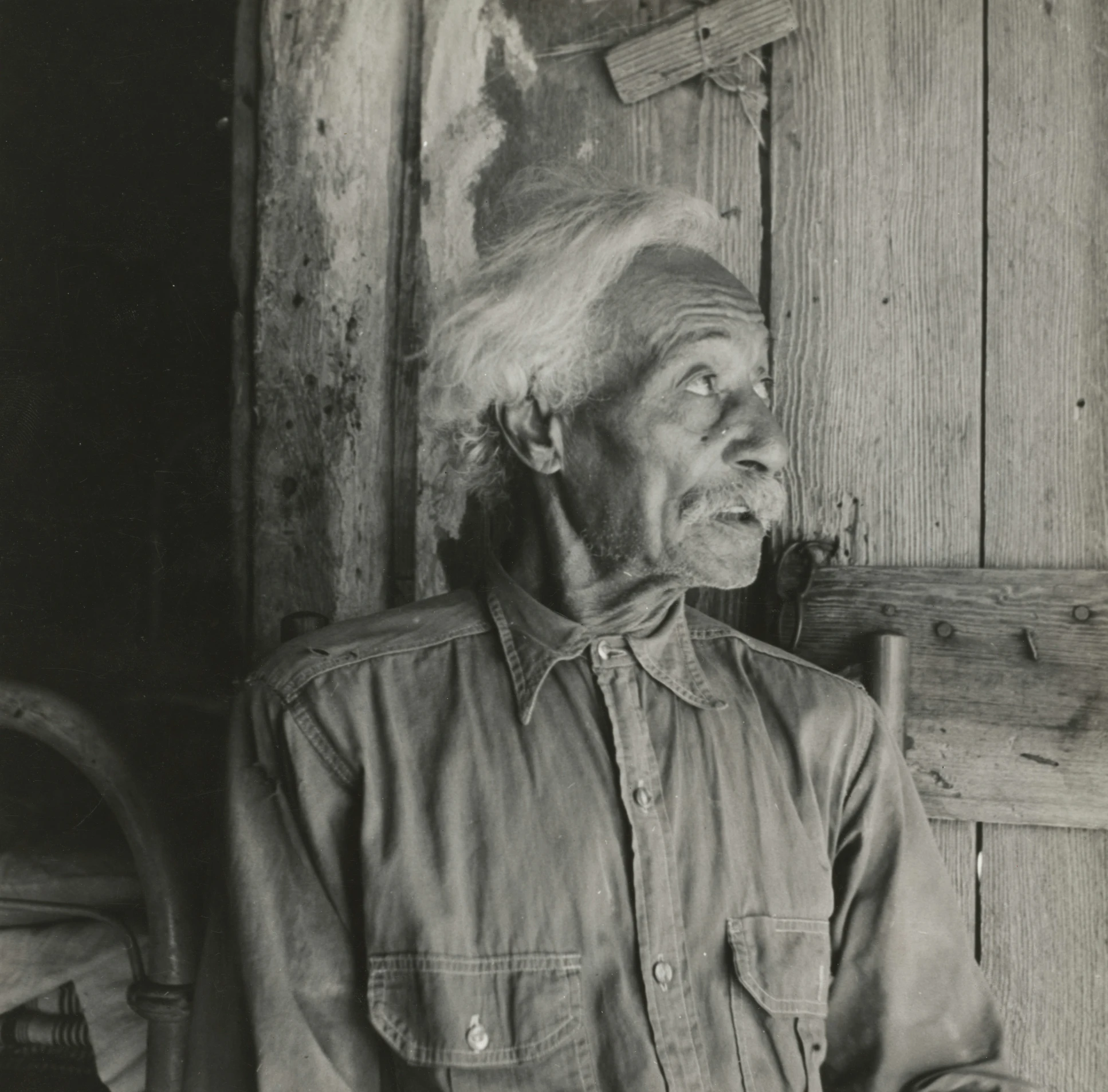 black and white image of a man wearing a hat