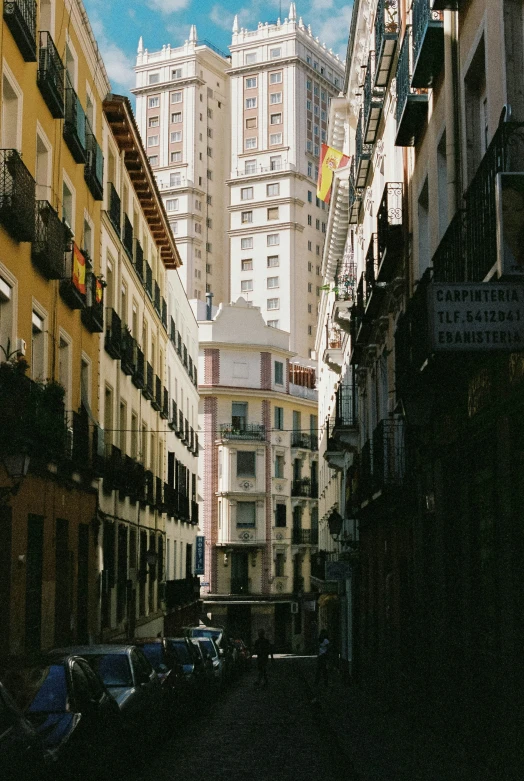 a street with various cars and buildings lining it