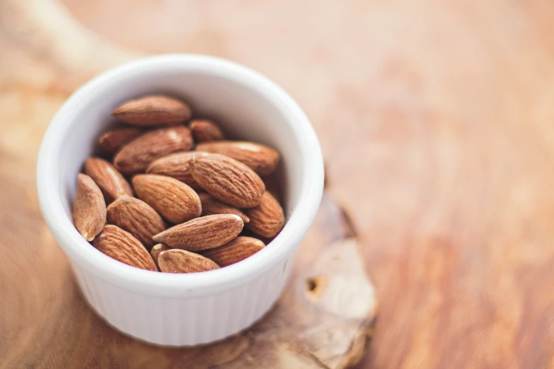 an empty bowl with nuts sitting on a table