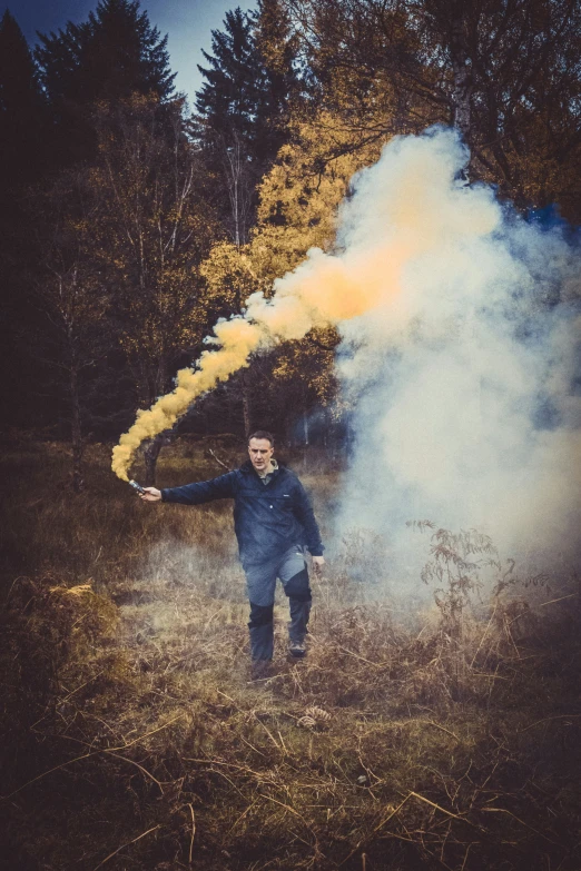 a man throwing a black smoke bomb into the air