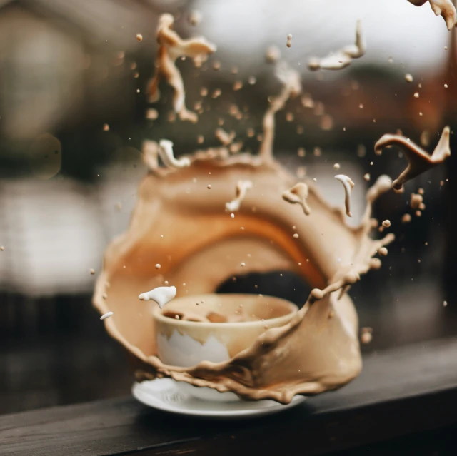 a liquid splash on top of a coffee cup